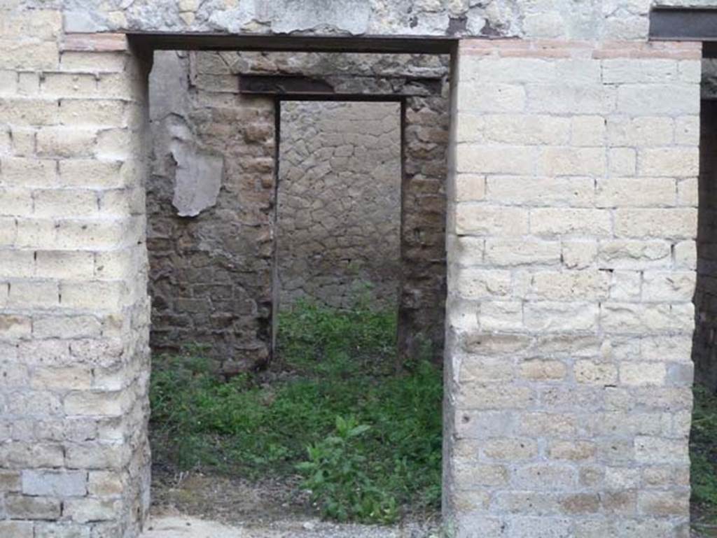 Ins. Orientalis II.18, Herculaneum. September 2015. Doorway to room at north end of east wall, with doorway through to a rear room.